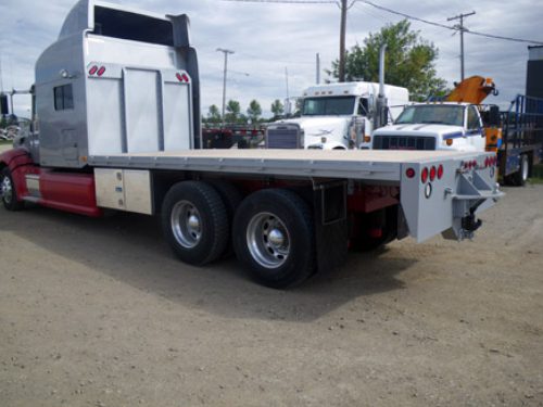 Professional industrial welder welding metal parts in metalworking factory