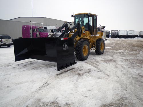 Professional industrial welder welding metal parts in metalworking factory