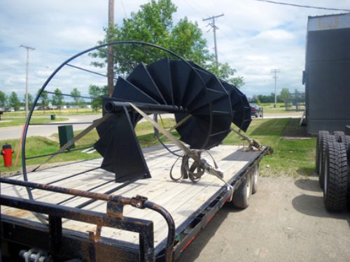 Professional industrial welder welding metal parts in metalworking factory