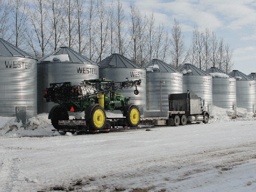 Professional industrial welder welding metal parts in metalworking factory