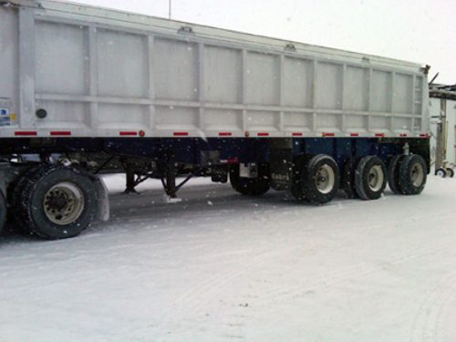 Professional industrial welder welding metal parts in metalworking factory